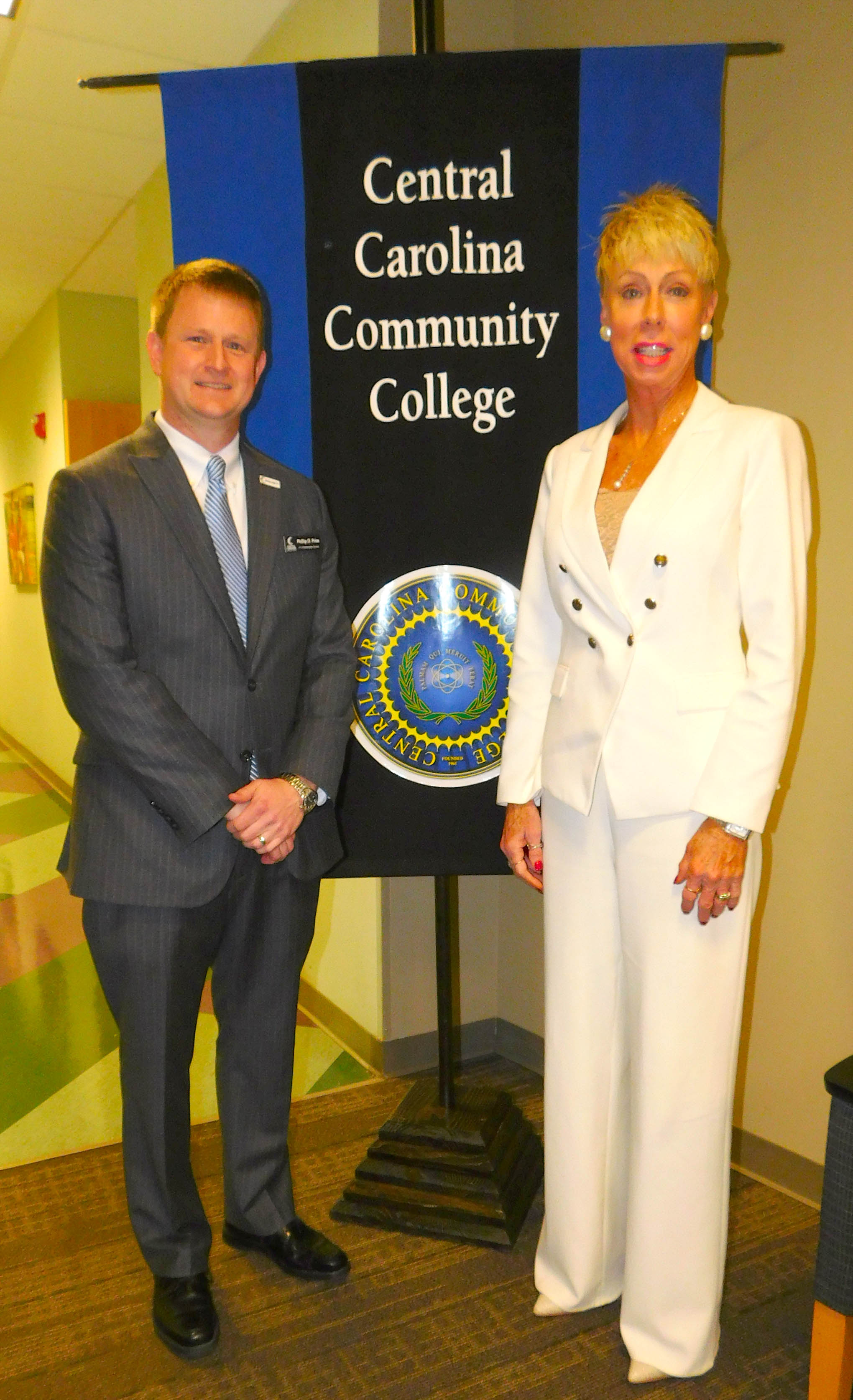 Click to enlarge,  North Carolina State Auditor Beth A. Wood (right) visits with Phillip Price (left), Central Carolina Community College Vice President of Administrative Services. 