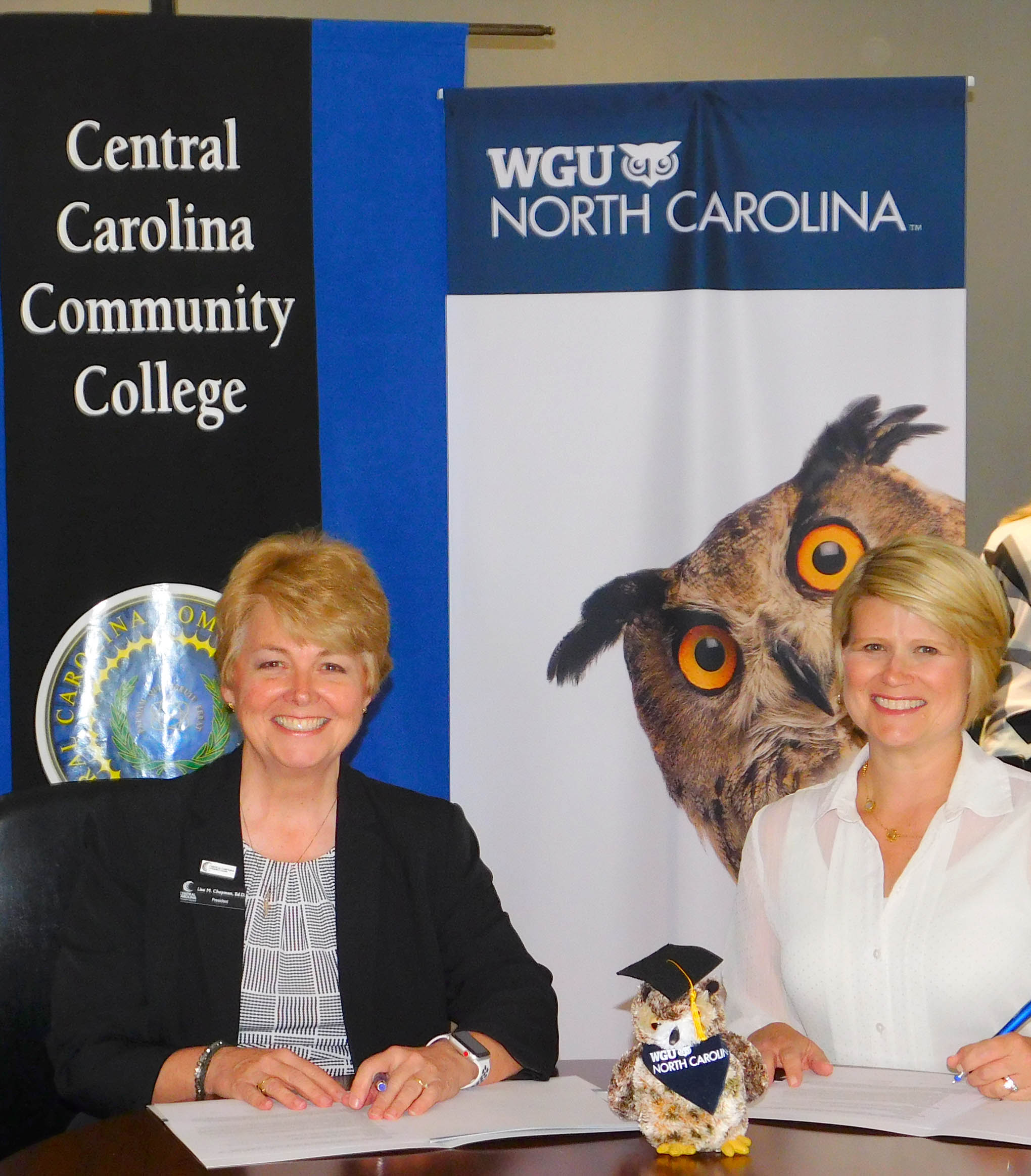 Click to enlarge,  Central Carolina Community College President Dr. Lisa M. Chapman (left) and WGU North Carolina Chancellor Catherine Truitt (right) sign a Memorandum of Understanding that will ease the transition for CCCC graduates to pursue bachelor's degrees offered by WGU, provide tuition discounts, and provide access to scholarship funds.  