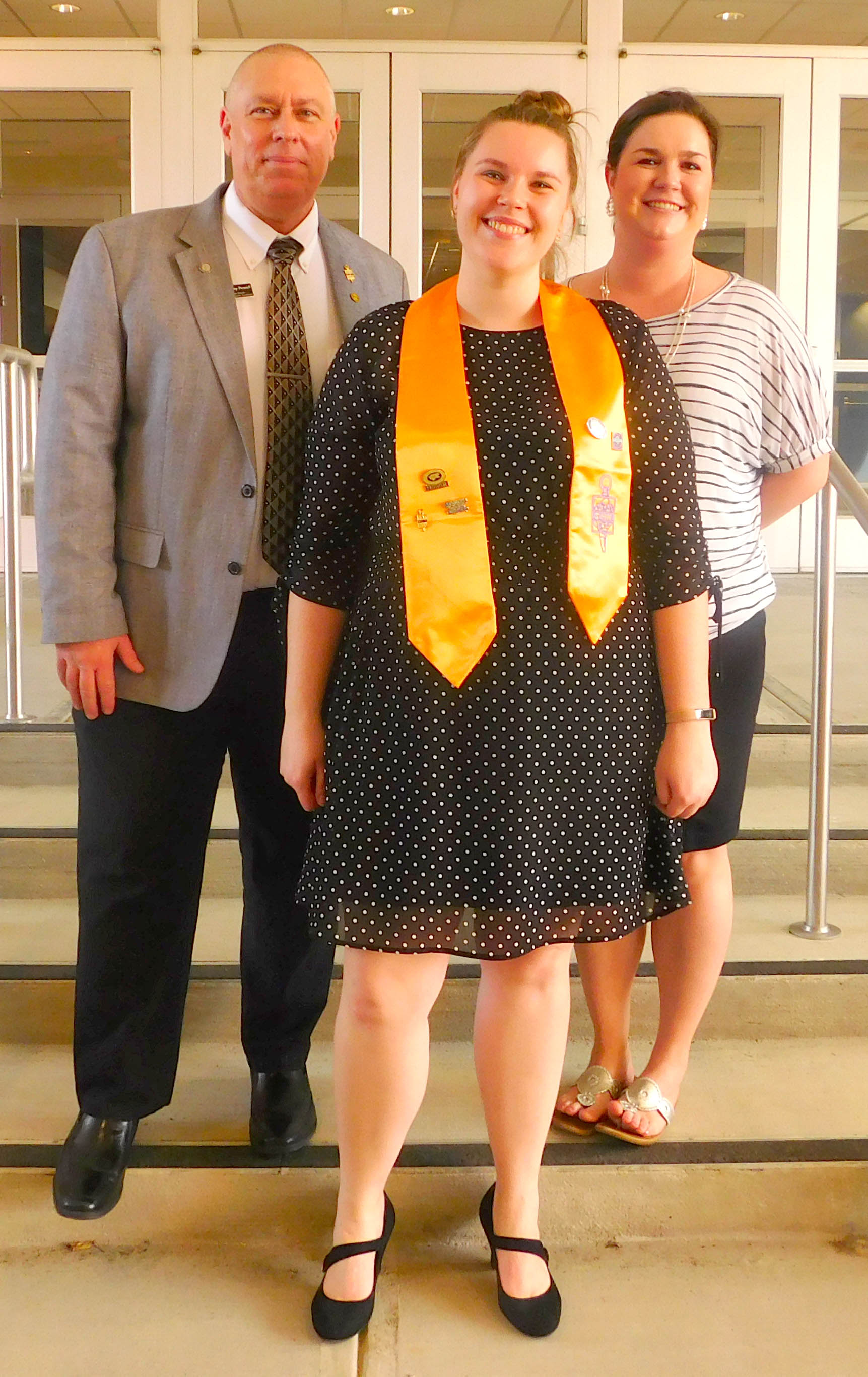 Click to enlarge,  Nicole Thompson (center), Phi Theta Kappa Alumna, was the speaker for the Central Carolina Community College Phi Theta Kappa International Honor Society spring induction ceremony. She is pictured with PTK Chapter Advisors Dr. Rodney Powell (left) and Dr. Emily Hare (right). 