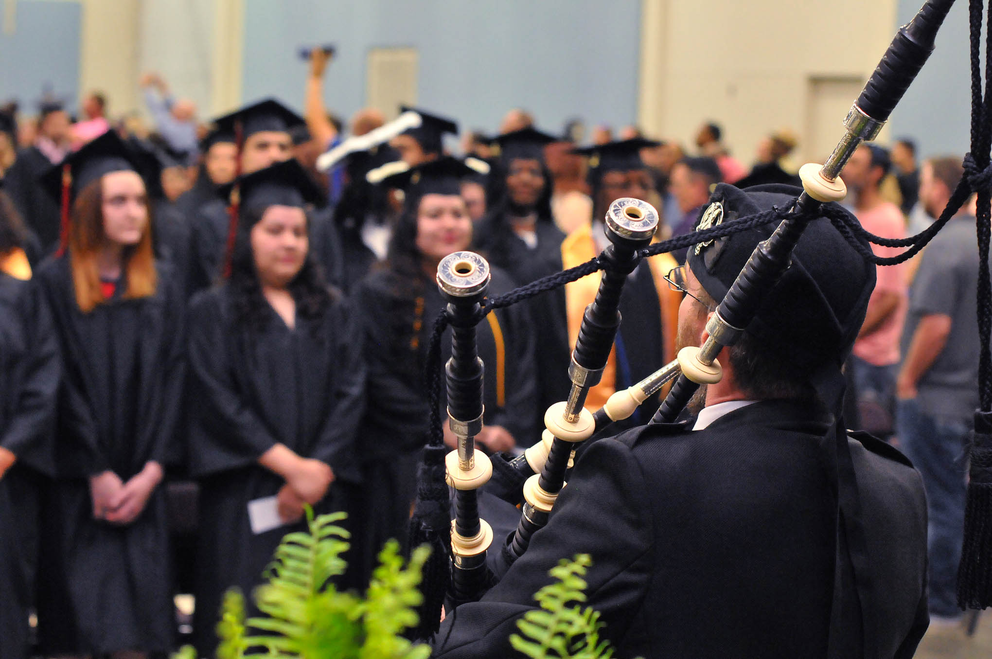 Click to enlarge,  The Central Carolina Community College graduating students entered the main hall to the skirl of a bagpipe, a CCCC tradition. The CCCC 56th Commencement Exercises was held May 13 at the Dennis A. Wicker Civic &amp; Conference Center in Sanford. 