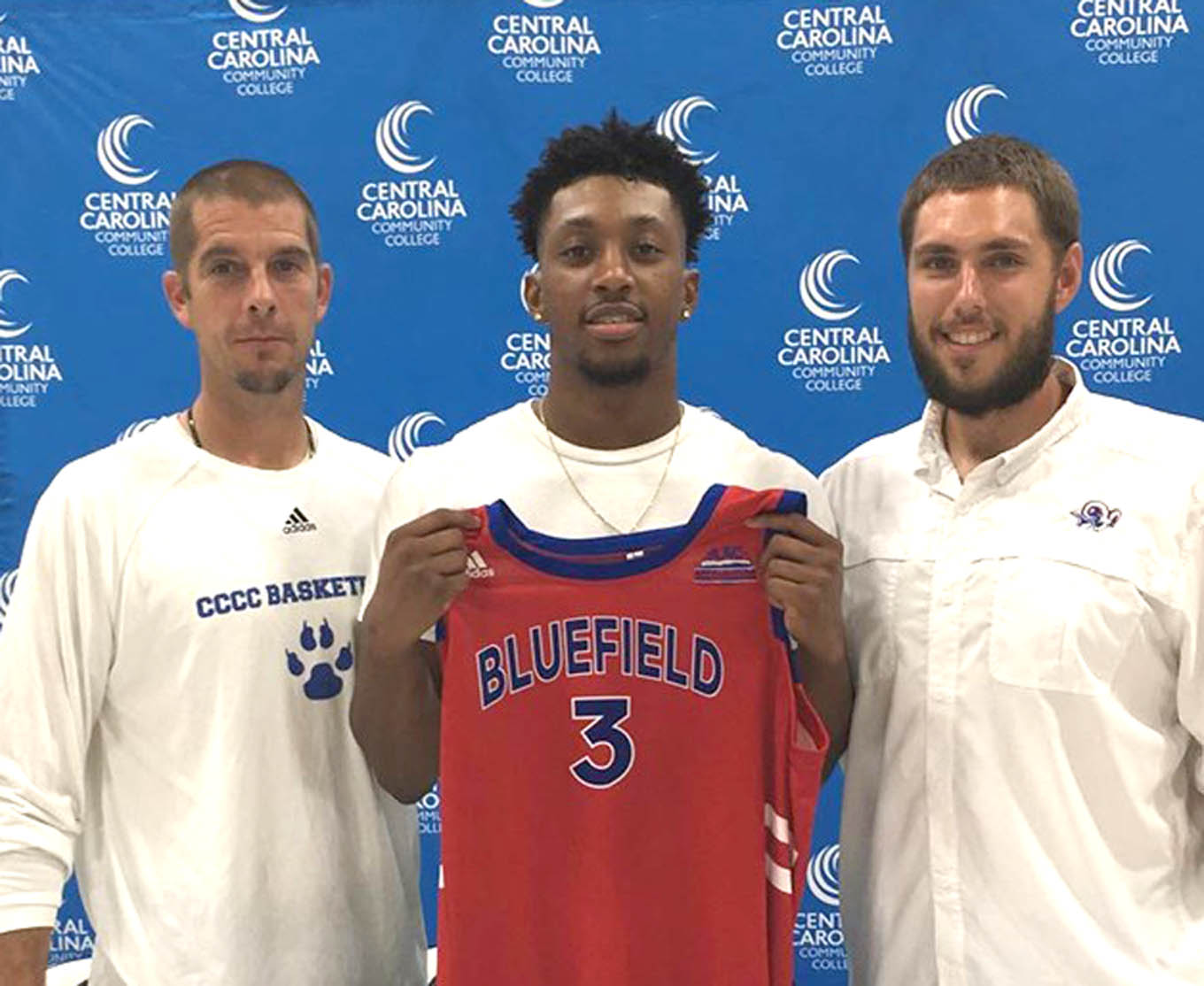 Click to enlarge,  Chris George (center), who was the Most Outstanding Sophomore on the Central Carolina Community College 2018-19 men's basketball team, has signed to play with Bluefield College in Bluefield, Va. George, a 6-foot-3 forward who played at Cape Fear High School in Cumberland County, averaged 11.2 points and 7.9 rebounds per game for the CCCC Cougars. Pictured with George are Central Carolina Community College Men's Basketball Coach Brad McDougald (left) and Bluefield College Assistant Coach Ryan Moody (right). Coach McDougald said of George: "Chris has been a fantastic young man his two years here. Chris has done all the right things, and is a positive influence to those around him.  He embodies what Cougar basketball is all about. It's been an absolute privilege to coach him and have him as part of this program." 