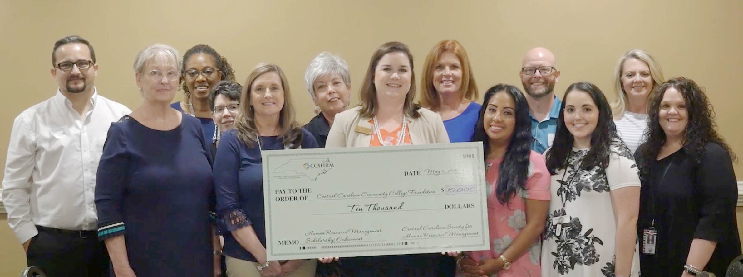 Click to enlarge,  Dr. Emily Hare (holding check), Executive Director of Central Carolina Community College (CCCC) Foundation, visits with Central Carolina Society for Human Resource Management (CCSHRM) members. CCSHRM has sponsored an endowment to create a legacy scholarship at CCCC.  