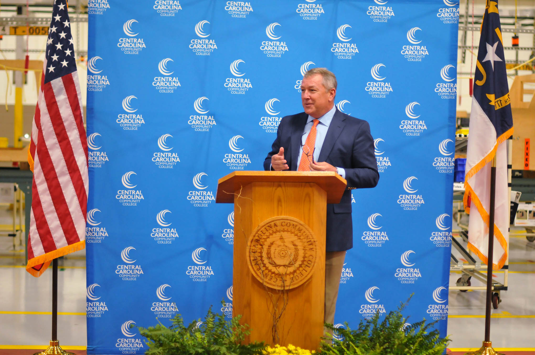 Click to enlarge,  Lee County Manager Dr. John A. Crumpton speaks at the Central Carolina Community College 10,000 hours of industrial training celebration event. 
