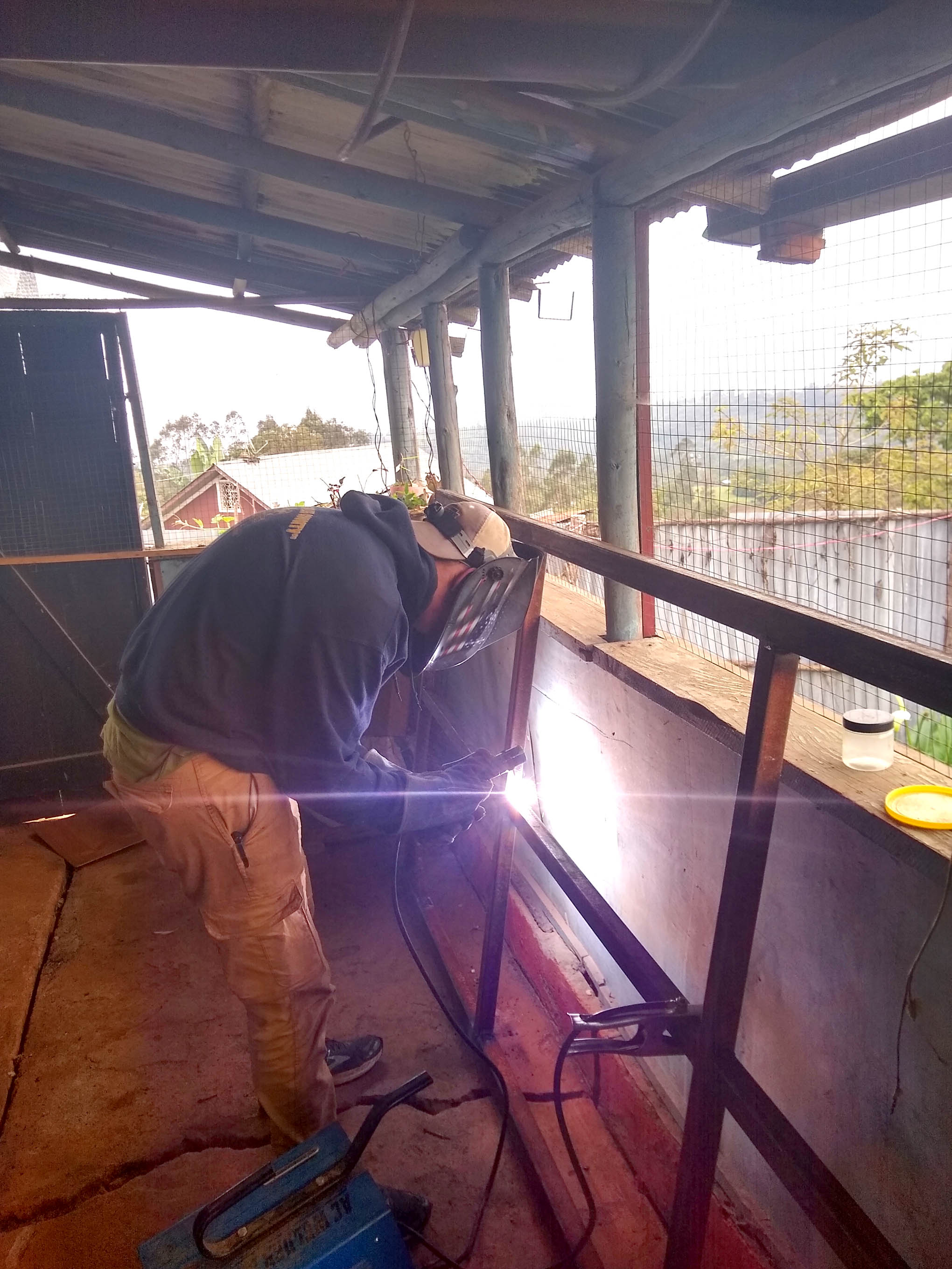 Click to enlarge,  Dylan Smith puts his welding skills to practice during his summer visit to the Ethiopian highlands. 