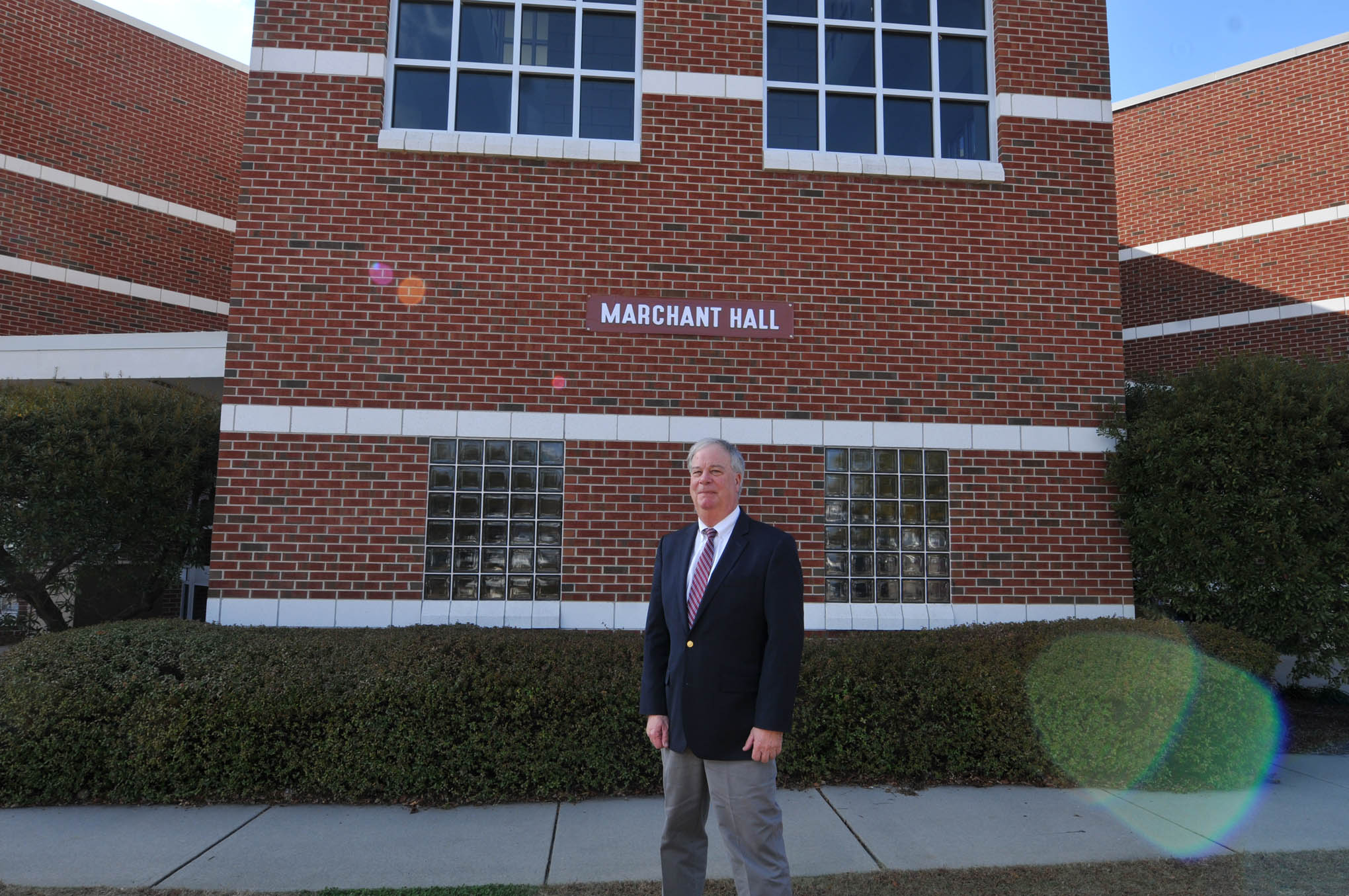 Click to enlarge,  Dr. T. Eston "Bud" Marchant is pictured in front of the building that now bears his name, Marchant Hall, on the Central Carolina Community College Lee Main Campus in Sanford, N.C. 
