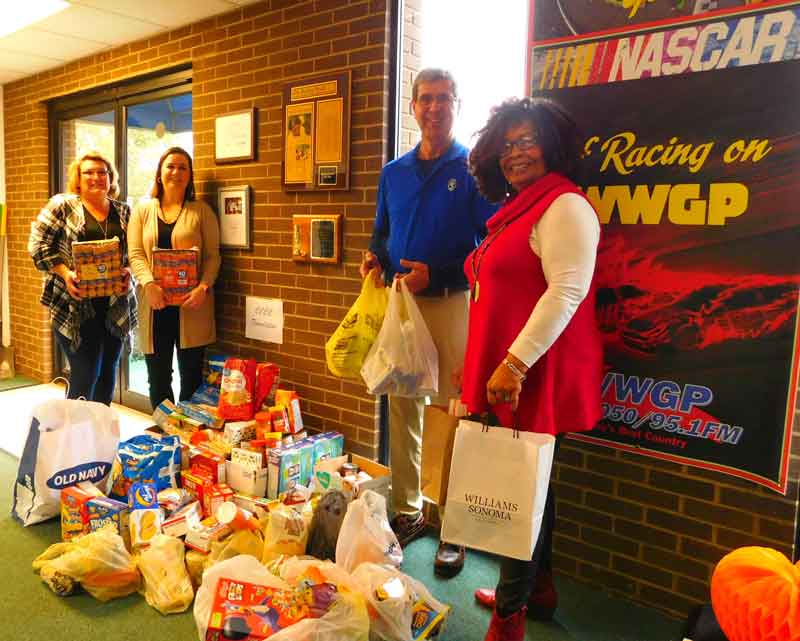 Click to enlarge,  The Ruby McSwain Cougar Market, Central Carolina Community College's Food Pantry, is the beneficiary of the generosity of the listeners of Sanford radio stations WWGP and WFJA. The radio stations accepted donations for several weeks to go toward the CCCC Food Pantry. Pictured here with the food donations are, left to right: CCCC Foundation Intern Brenda Walker, CCCC Foundation Executive Director Dr. Emily Hare, and WWGP-WFJA's Jon Hockaday and Margaret Murchison. The Cougar Market aspires to support student success by ensuring that no student goes hungry because of a lack of income or access to food. The Cougar Market is stocked with non-perishable snacks and meal items to temporarily alleviate immediate food insecurity for students and their families. In cases of persistent lack of access to food, Cougar Market works with students to connect them to appropriate community resources. For more information on the CCCC Food Pantry, contact Dr. Hare at 919-718-7230 or ehare@cccc.edu. 