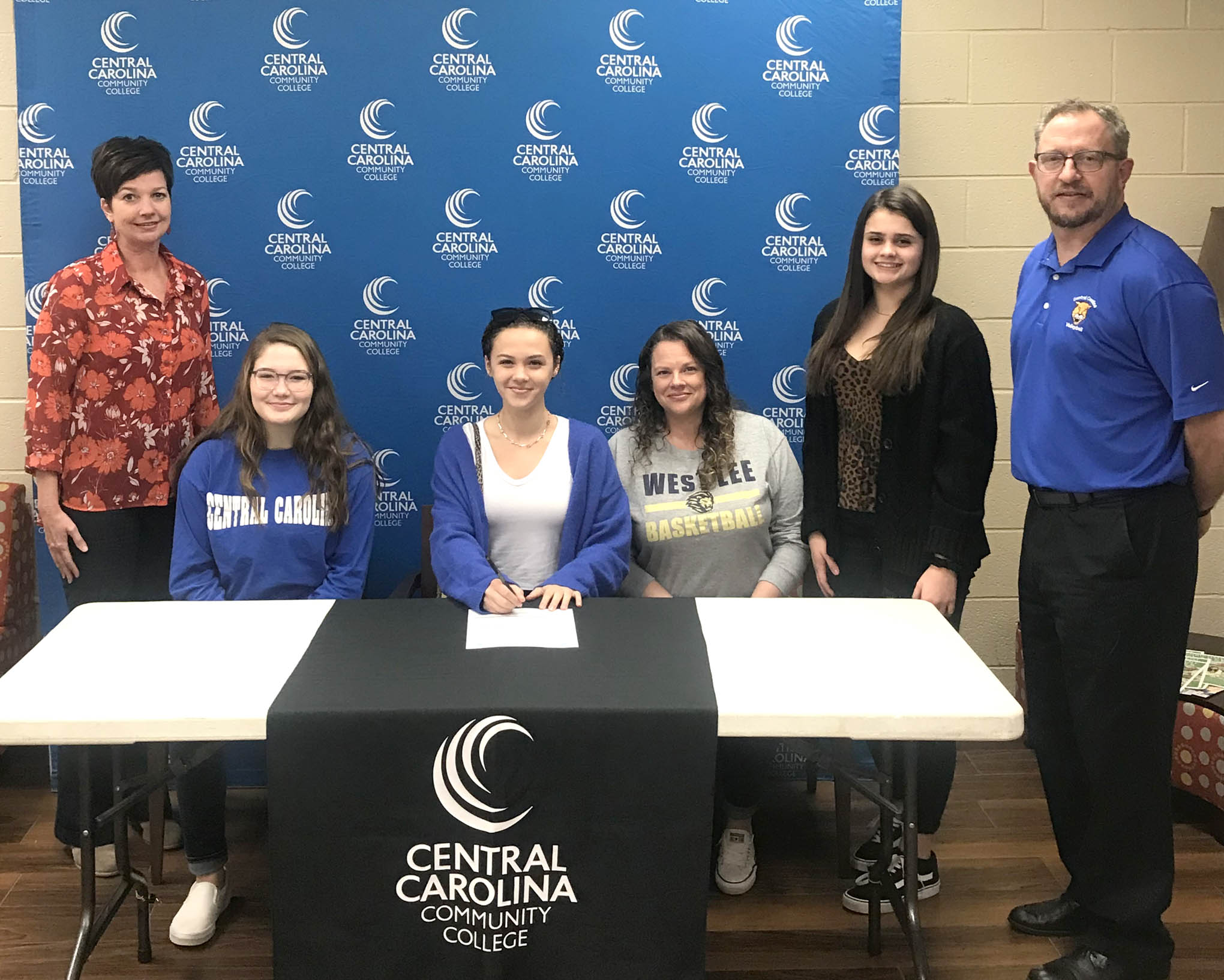Click to enlarge,  Lily Bonner signs her letter of intent to play volleyball at Central Carolina Community College. 