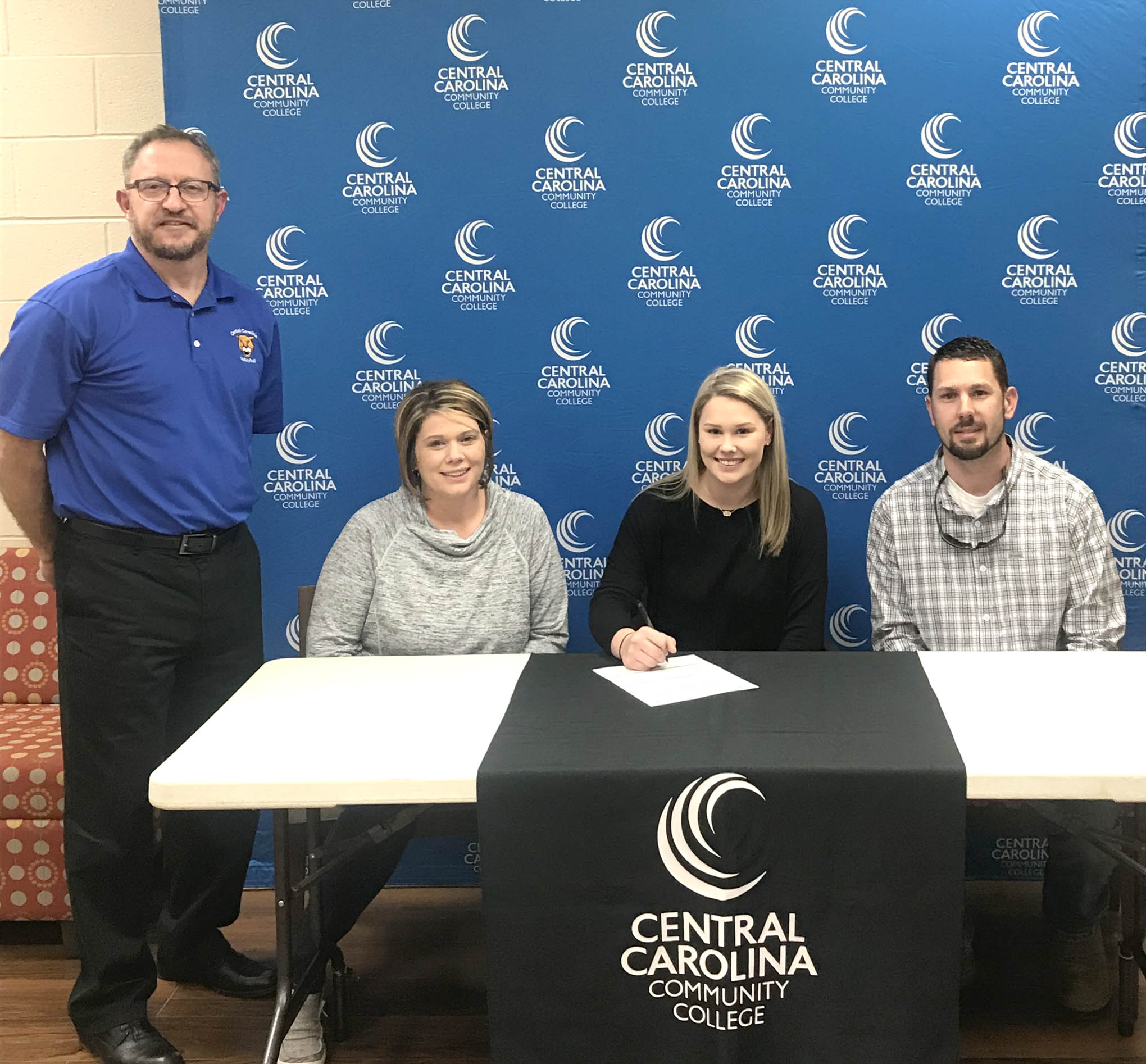 Click to enlarge,  Mekenzie Harris signs her letter of intent to play volleyball at Central Carolina Community College. 