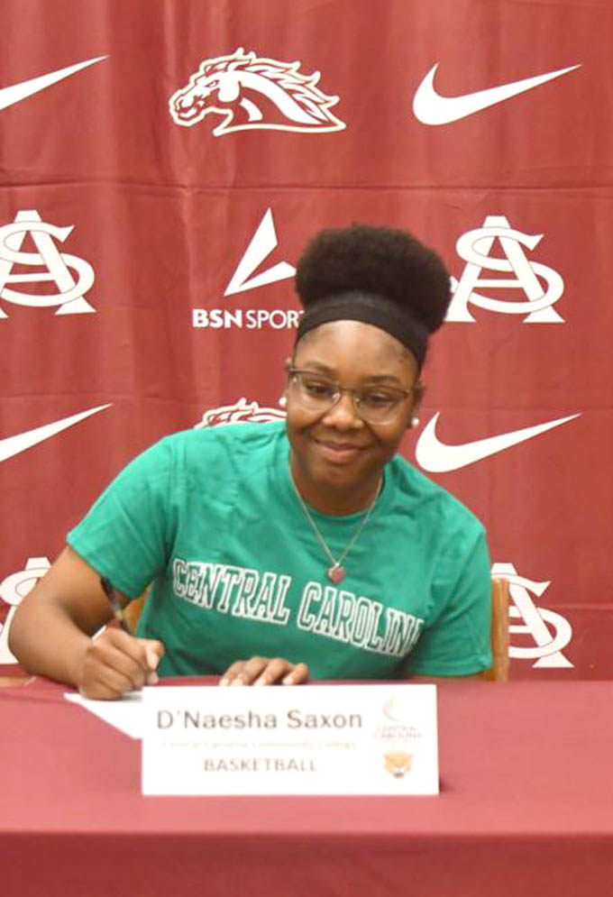 Click to enlarge,  D'Naesha Saxon, of South Aiken High School in Aiken, S.C., signs with the Central Carolina Community College women's basketball program. For more information about Central Carolina Community College and its programs, visit its website, www.cccc.edu, or call the college at 919-775-5401. 
