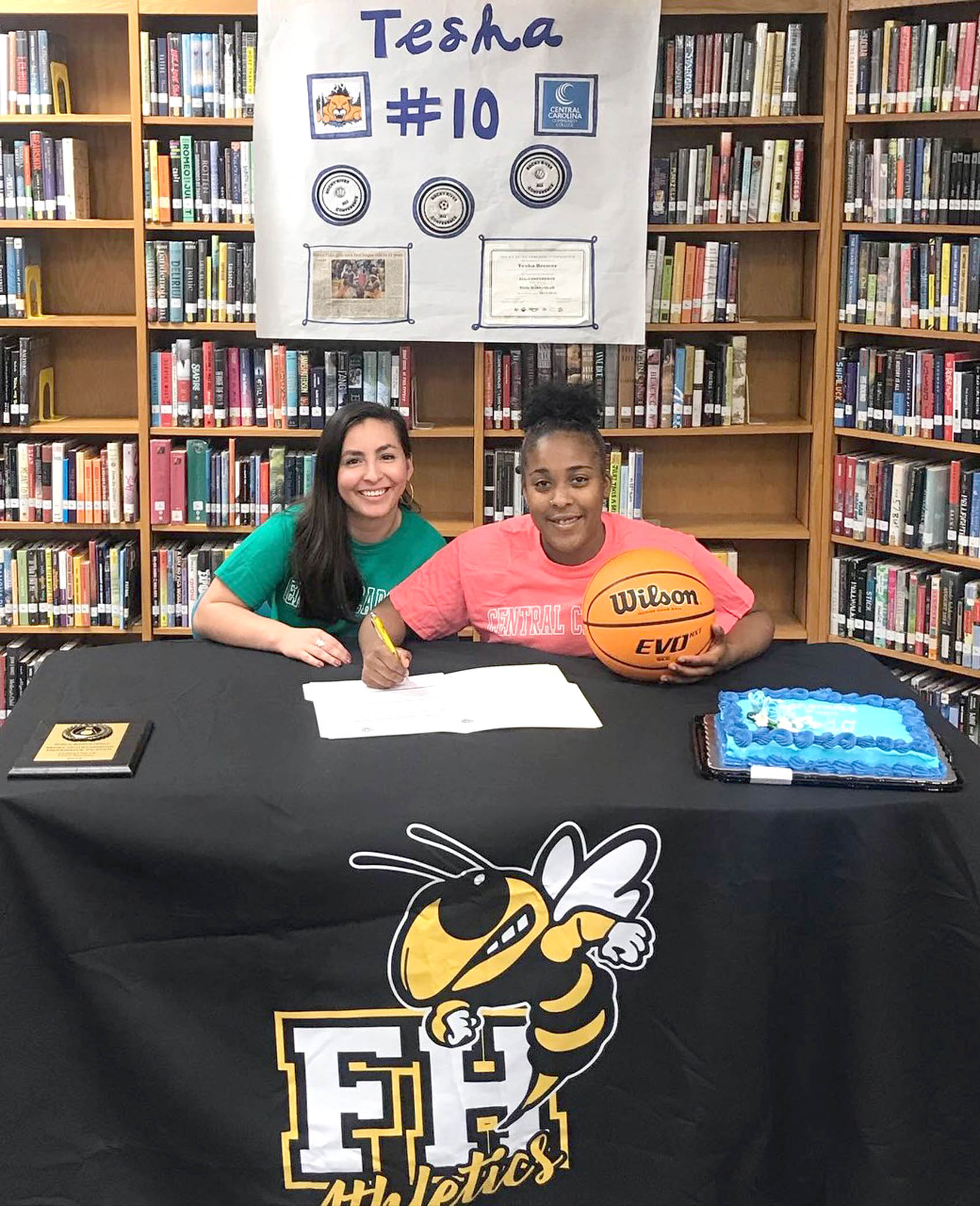 Click to enlarge,  Tesha Brewer (right), of Forest Hills High School in Marshville, N.C., signs with the Central Carolina Community College women's basketball program. At left is Itziri Gonzalez-Barcenas, a guidance counselor at the high school. For more information about Central Carolina Community College and its programs, visit its website, www.cccc.edu, or call the college at 919-775-5401. 
