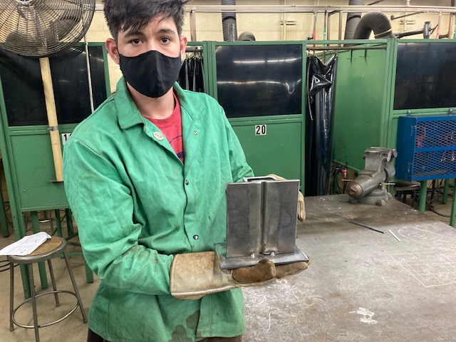 Click to enlarge,  Dylan Smith shows off a welding creation. 