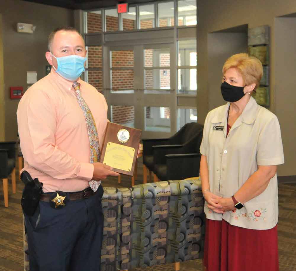 Click to enlarge,  Brian Estes (left) has received the Central Carolina Community College Adjunct of the Year Award. Mr. Estes, who was recognized at the recent CCCC Convocation program, teaches in the CCCC Basic Law Enforcement Training Program. Pictured at right is CCCC President Dr. Lisa M. Chapman. 