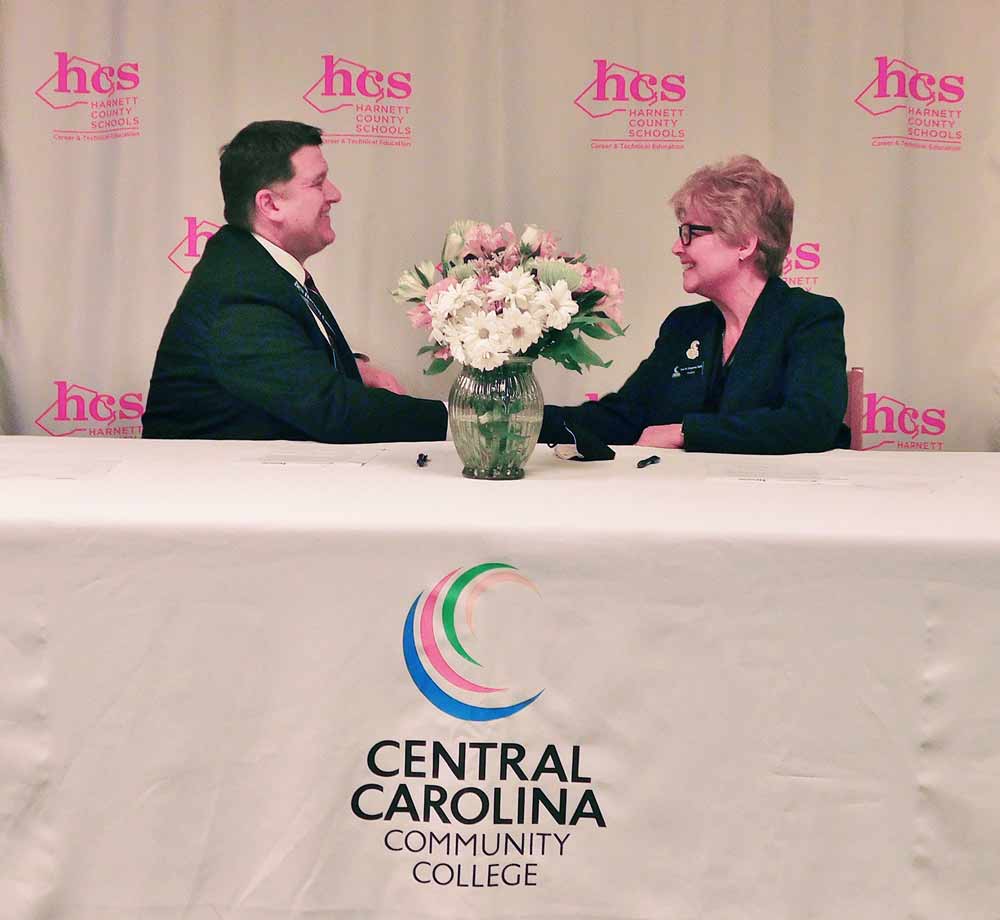 Click to enlarge,  Harnett County Schools Superintendent Dr. Aaron L. Fleming (left) and Central Carolina Community College President Dr. Lisa M. Chapman (right) are all smiles after signing an agreement for the formation of the Harnett Agriculture Academy. The signing ceremony was held Wednesday, Feb. 23, at Triton High School in Erwin, N.C. 