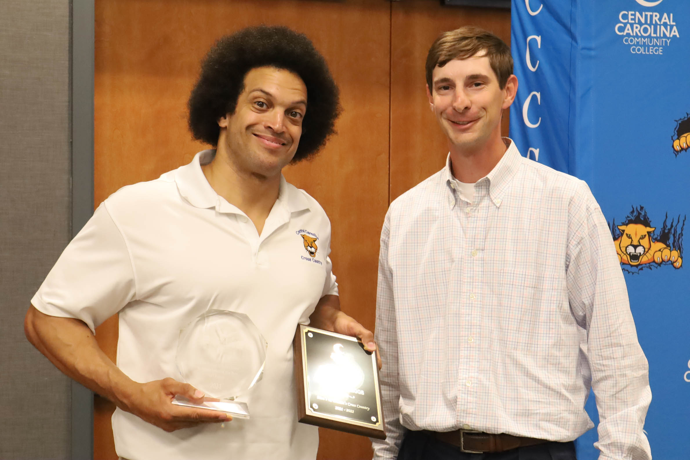 Click to enlarge,  Coach Richard Briggs (left) has been recognized as the National Junior College Athletic Association (NJCAA) Division III East Region Women's Coach of the Year by the U.S. Track and Field and Cross Country Coaches Association. Coach Briggs is pictured with CCCC Athletic Director Jonathan Hockaday (right). 