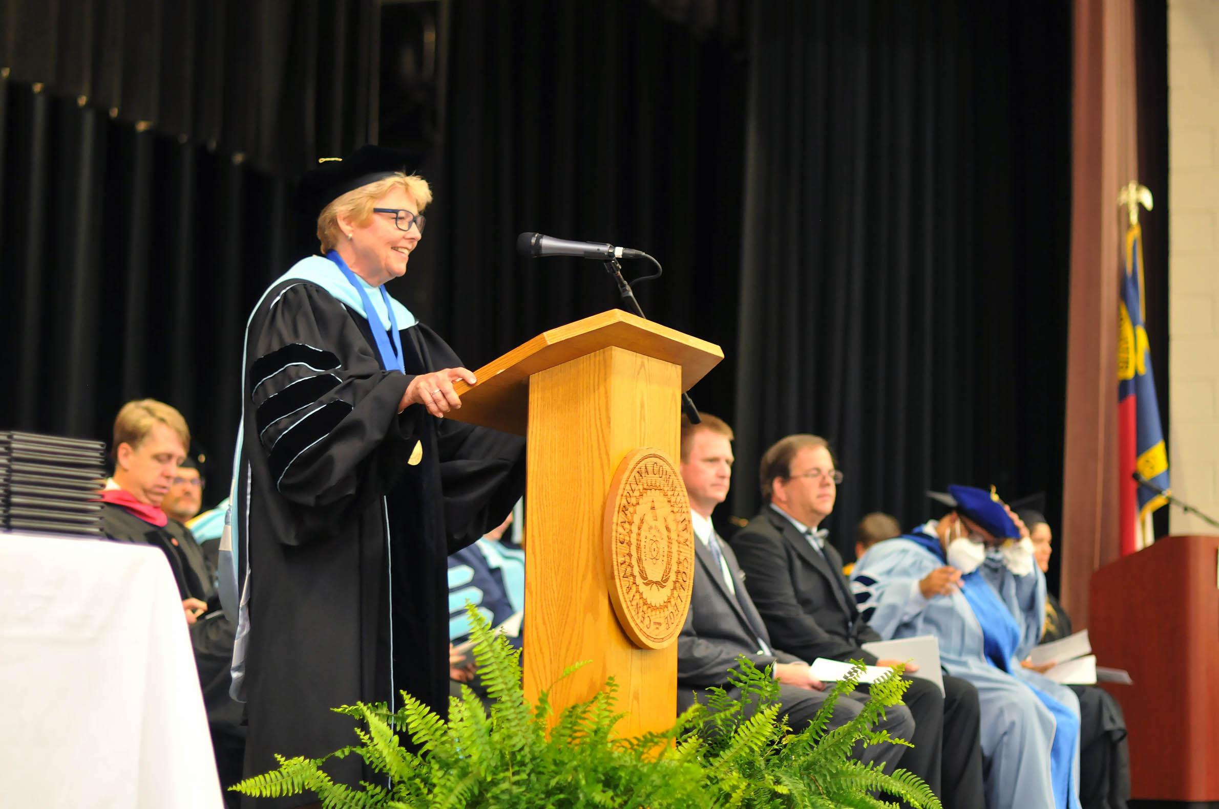 Click to enlarge,  Dr. Lisa M. Chapman, Central Carolina Community College President, speaks to graduates at the 60th Commencement Exercises on Aug. 9 at the Dennis A. Wicker Civic &amp; Conference Center in Sanford. 