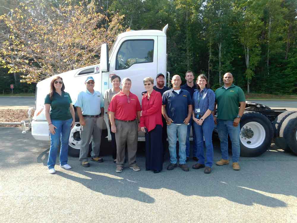 Click to enlarge,  The Central Carolina Community College Foundation has received a gift from Mountaire Farms Inc. of a 2015 T680 Day Cab Tractor that will be used in the college's Commercial Truck Driver Training Program. Pictured are, left to right: Cassey Morris, Mountaire Director of Transportation; Darrell McLaurin, CCCC Truck Driver Training Coordinator; Pamela Fincher, CCCC Director - Business &amp; Applied Technologies; Pat Townsend, Mountaire Director of Human Resources Administration; Margaret Roberton, CCCC Vice President for Workforce Development; Jimmy Usher, Mountaire Diesel Mechanic; Teddy Jackson, Mountaire Fleet Maintenance Manager; David Dubuke, Mountaire Fleet Operations Manager; Amanda Irwin, Mountaire Vice President of Processing Operations; and Martin Perez, Mountaire Dresshaul Driver. 