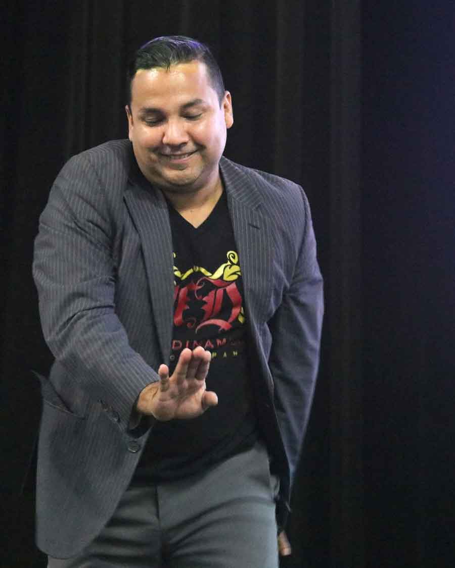 Click to enlarge,  Norberto "Betto" Herrera, director of the Mambo Dinamico dance company, demonstrates some common steps in Latin American salsa and explains how they derived from storytelling. 